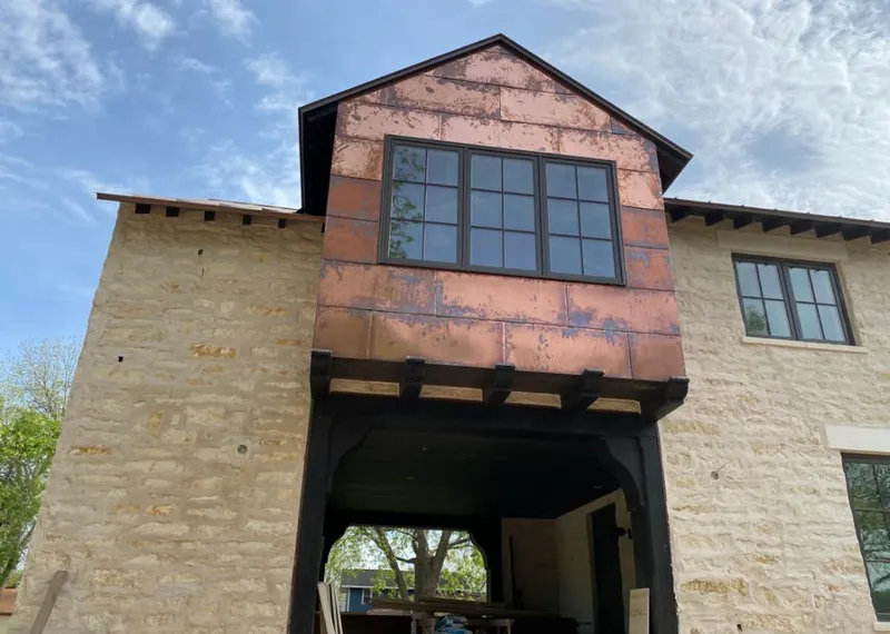 Copper metal panel facade on a stone building for Skylight Installation in Marshall